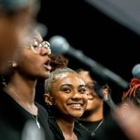 choir sings in front of microphones